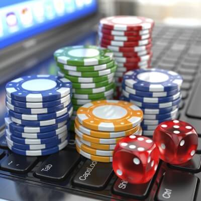 Virtual casino. Online gambling. Laptop with dice and chips.